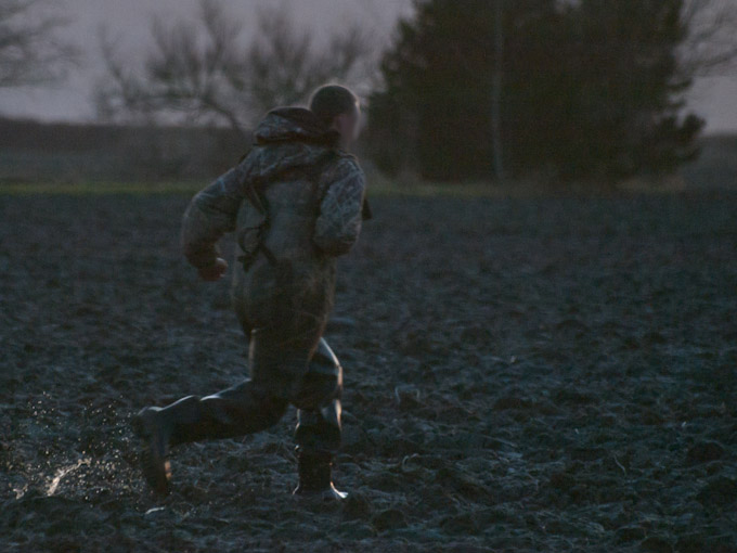 Hunter Chasing Injured Snow Goose